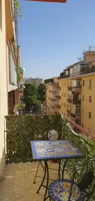 a table and chairs on the balcony of a building at Magia del Sud in Palermo