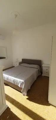 a bedroom with a bed and two night stands at Magia del Sud in Palermo