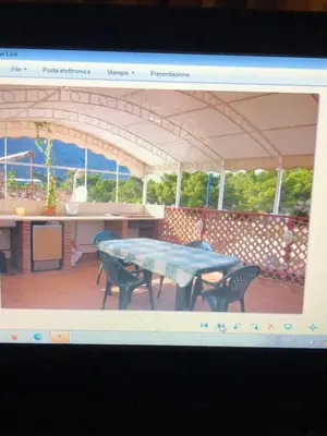 a picture of a patio with a table and chairs at Chiaro di luna holiday in Palermo