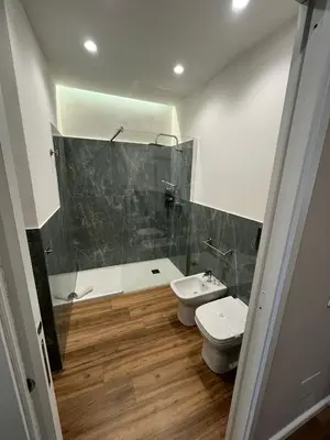 a bathroom with a shower and a toilet and a sink at Maison Butera in Palermo