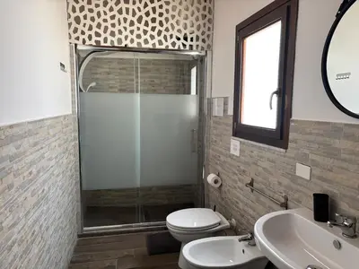 a bathroom with a shower and a toilet and a sink at Historic Center - Apartment with 2 Bedrooms in Palermo