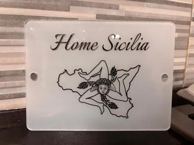 a sign for a home studio with a drawing of a woman at Home Sicilia in Carini