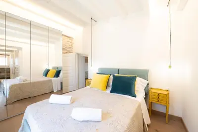 a bedroom with two beds and a mirror at Villa Baja Scopello in Balata di Baida