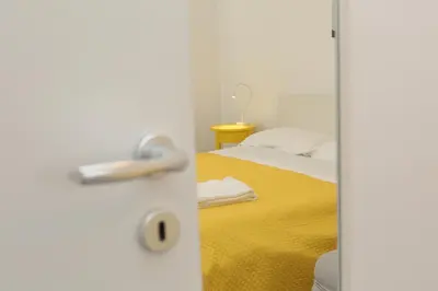 a bedroom with a bed and a door with a mirror at Casa Verdemare in Cefalù