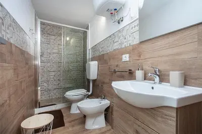 a bathroom with a sink and a toilet at Vicoloft al Capo in Palermo