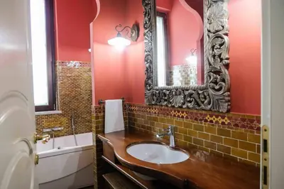 a bathroom with a sink and a mirror at High-end apartment in the city center in Palermo