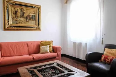 a living room with a couch and a table at High-end apartment in the city center in Palermo