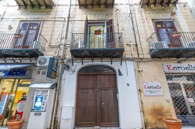 a building with a door and a balcony at Al Mondellu apt Verosicily in Palermo