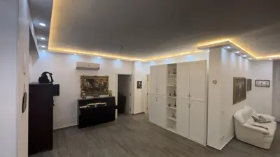a living room with white cabinets and a chair at Vanila Dream's House in Palermo