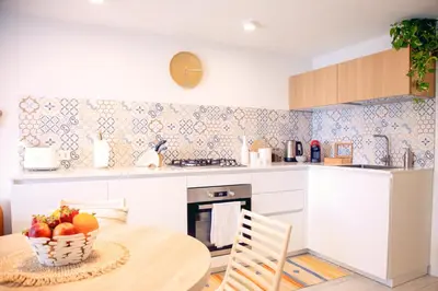 a bedroom with a white bed with two night stands at Marina Beach Apartments in Alcamo