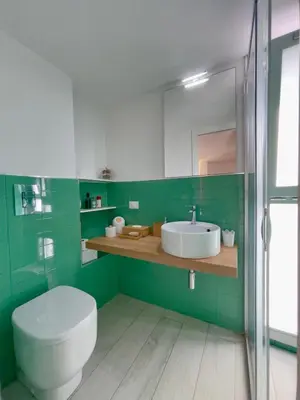 a kitchen with a table and chairs in a room at Marina Beach Apartments in Alcamo