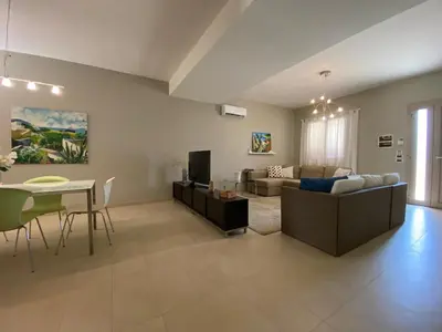 a living room with a couch and a table at Nereide home 350 sqm with large garden in Balestrate