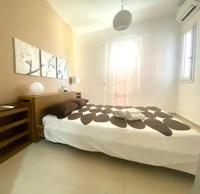 a bedroom with a large bed and a window at Nereide home 350 sqm with large garden in Balestrate