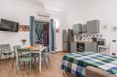 a room with a kitchen and a table and chairs at Ballaria in Palermo