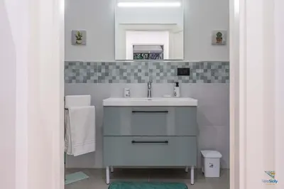 a bathroom with a sink and a mirror at Ballaria in Palermo