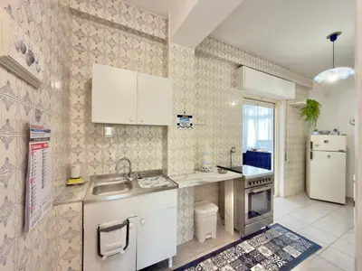 a small kitchen with a sink and a refrigerator at Merlo Holiday Homes Attico in Palermo