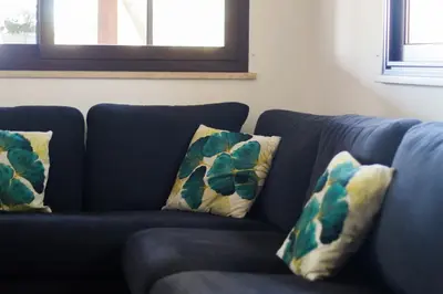 a blue couch with two pillows on it at Villa Adelaide in Cinisi