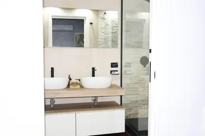 a bathroom with two sinks on a wooden counter at Villa Adelaide in Cinisi