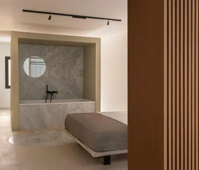 a bedroom with a bed and a bath tub at Aloe -lounge and Jacuzzi- in Palermo