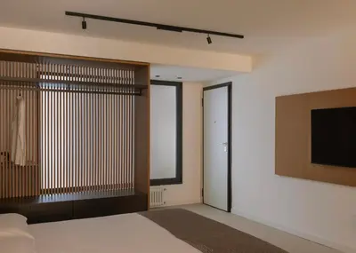 a bedroom with a bed and a television on a wall at Aloe -lounge and Jacuzzi- in Palermo