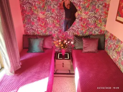 a person standing in a room with two beds at Nanà in Movida in Palermo