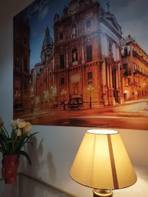 a picture of an old building with a lamp at Nanà in Movida in Palermo
