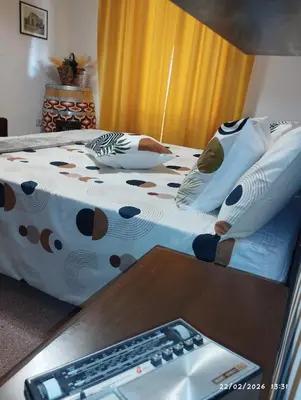 a bedroom with two beds and a desk with a keyboard at Nanà in Movida in Palermo