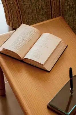 an open book sitting on a table with a tablet at Agelina square Home Gibellina in Nuova Gibellina