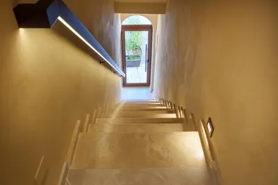 a hallway with stairs leading to a door at La Piazzetta Sea Rooms in Balestrate