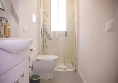 a bathroom with a shower and a toilet and a sink at Solemar Sicilia - Casa Belle in Palermo