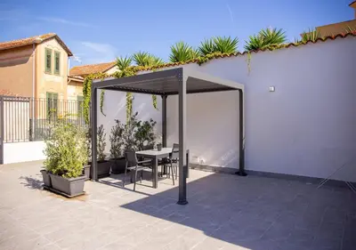 a pavilion with a table and chairs on a patio at Solemar Sicilia - Casa Belle in Palermo