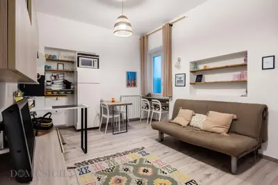a living room with a couch and a table at Carducci Apartment By DomuSicily in Palermo