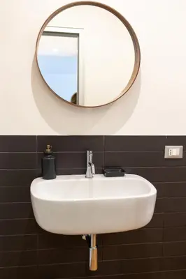 a white sink in a bathroom with a mirror at The Nest Maqueda in Palermo