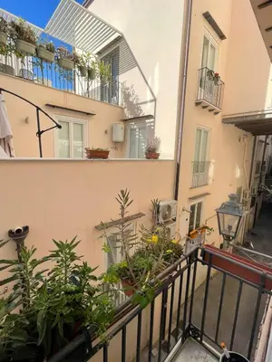 a balcony with plants on the side of a building at The Nest Maqueda in Palermo