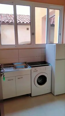 a kitchen with a washing machine and a washer at Casa degli Angeli Castellammare del Golfo TP Sicilia in Castellammare del Golfo