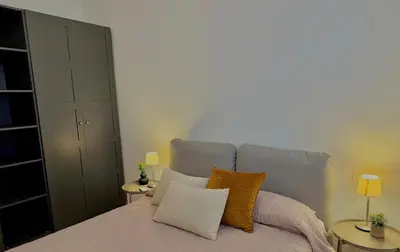 a bedroom with a bed with two tables and two lamps at Haus Mignon - Bright flat in Palermo Center in Palermo