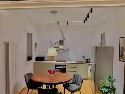 a kitchen with a table and chairs in a room at Haus Mignon - Bright flat in Palermo Center in Palermo