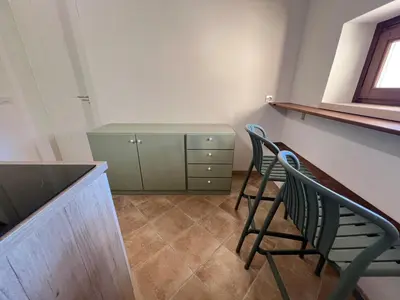 a room with two chairs and a counter and a cabinet at RossoScirì in Calatafimi