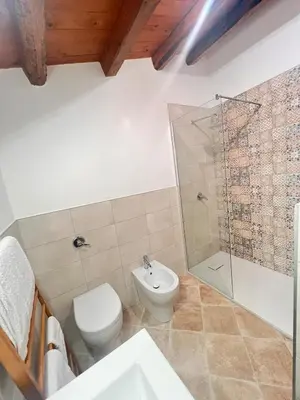 a bathroom with a toilet and a shower and a sink at RossoScirì in Calatafimi