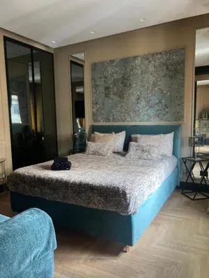 a bedroom with a bed with a painting on the wall at SCJAVURU of HOME in Palermo