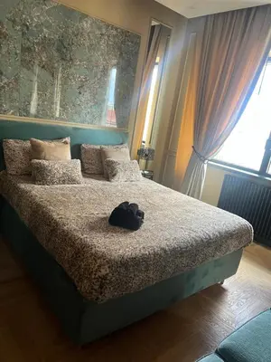 a bedroom with a bed with a hat on it at SCJAVURU of HOME in Palermo