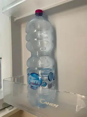 a bottle of water sitting on top of a refrigerator at Luma Sixty nine in Alcamo