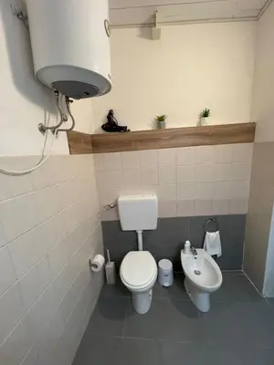 a bathroom with a toilet and a sink at Luma Sixty nine in Alcamo