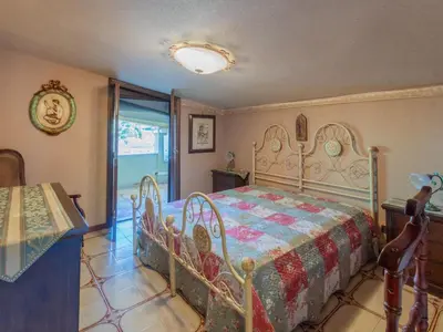 a bedroom with a bed in a room with a window at Casa San Nicola Trabia Mare in Trabia