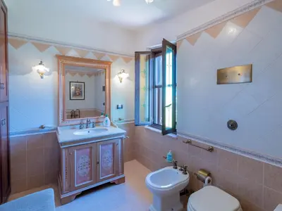 a bathroom with a toilet and a sink and a mirror at Casa San Nicola Trabia Mare in Trabia