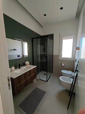 a bathroom with a toilet and a sink and a shower at Alla Metro in Capaci