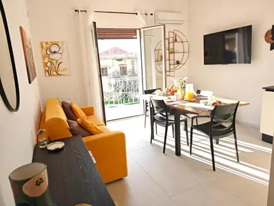 a living room with a yellow couch and a table at Alla Metro in Capaci