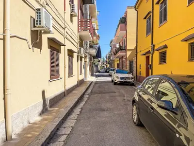 two cars parked on a narrow street with buildings at Apartment Sea Living Sicilia Apartment by Interhome in Santa Flavia