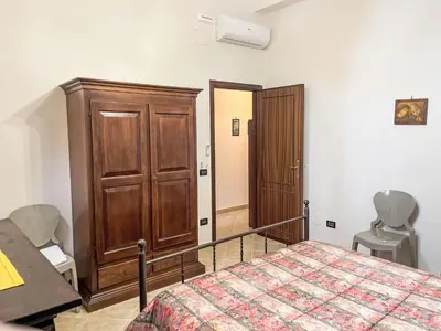 a bedroom with a bed and a wooden cabinet at Apartment Sea Living Sicilia Apartment by Interhome in Santa Flavia