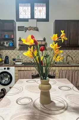 a vase of flowers on a table in a kitchen at Apartment Sea Living Sicilia Apartment by Interhome in Santa Flavia